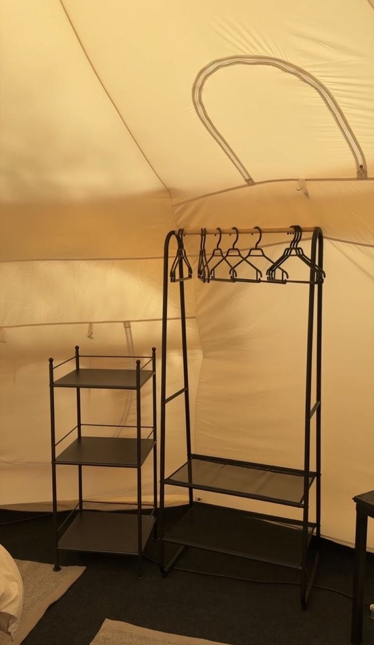 Colgador y repisas dentro de la carpa